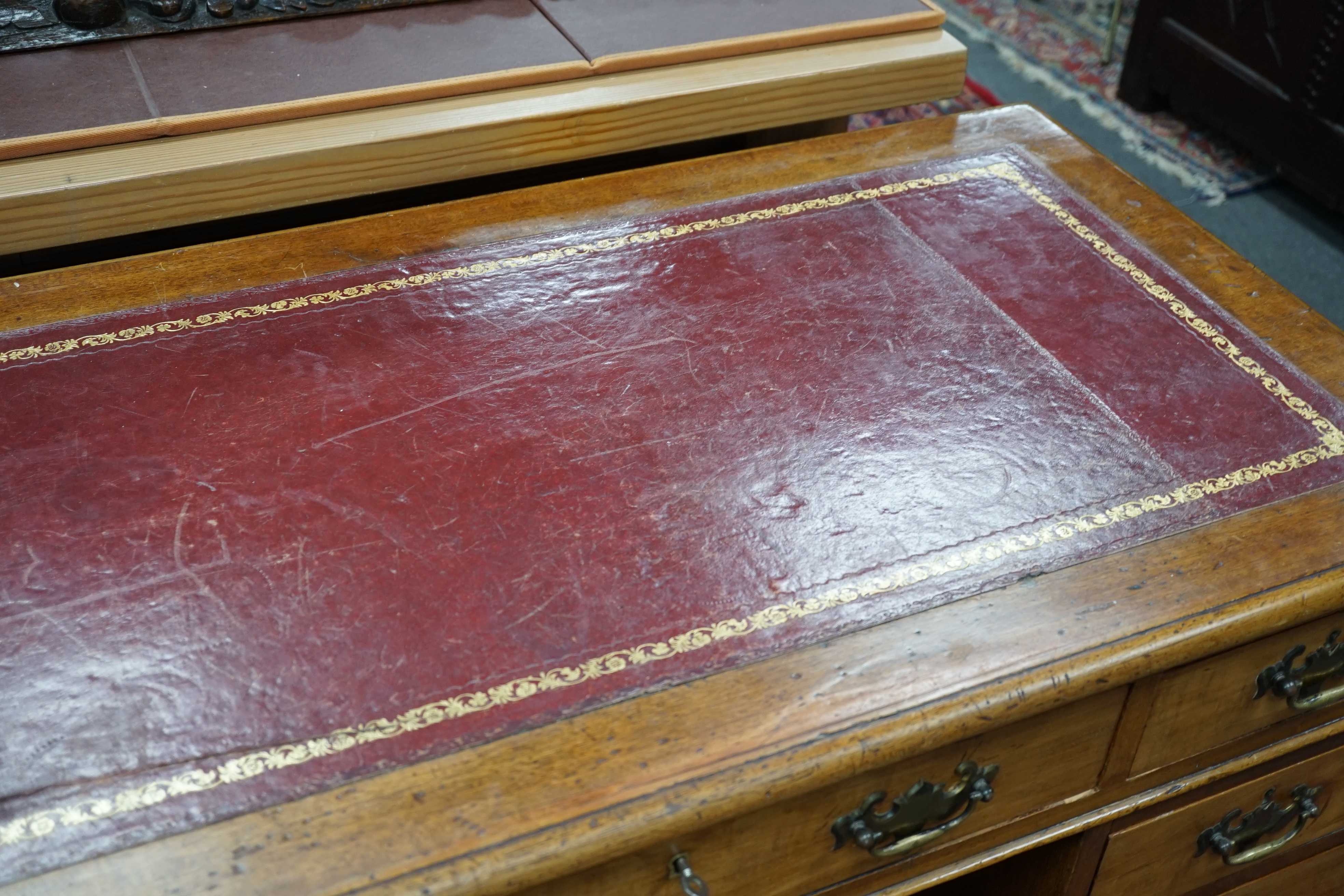 An Edwardian walnut leather-topped pedestal desk, width 120cm, height 72cm